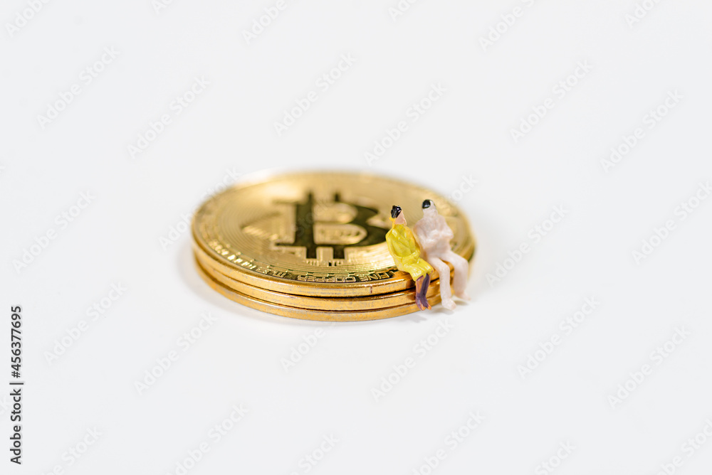 Two human figures sitting and talking on a crypto currency on white background Two human figures sitting and talking on a crypto currency on white background