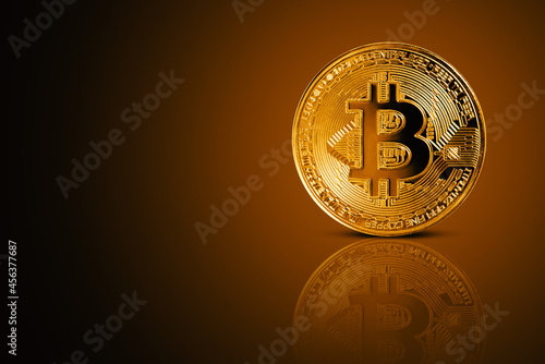 Front view of Bitcoin on gold background