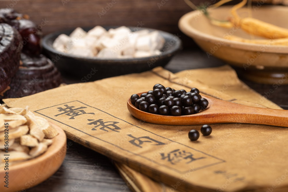 Ginseng and traditional Chinese medicine on the table.chinese translation:Emperor's Internal Classic Ginseng and traditional Chinese medicine on the table.chinese translation:Emperor's Internal Classic