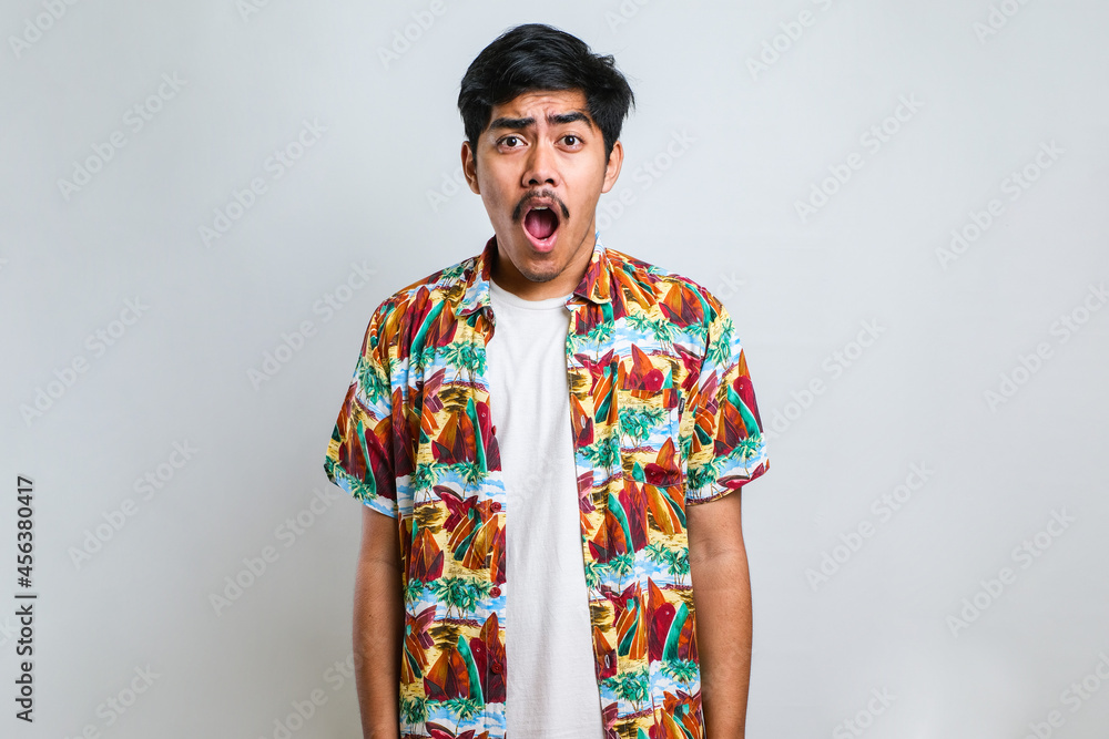 Amazed asian young man with open mouth and bulging eyes looking at camera Amazed asian young man with open mouth and bulging eyes looking at camera
