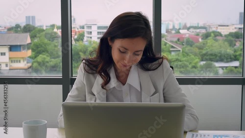 Beautiful woman in formal outfit get relax while working and using smartphone with happy emotion in modern workplace office