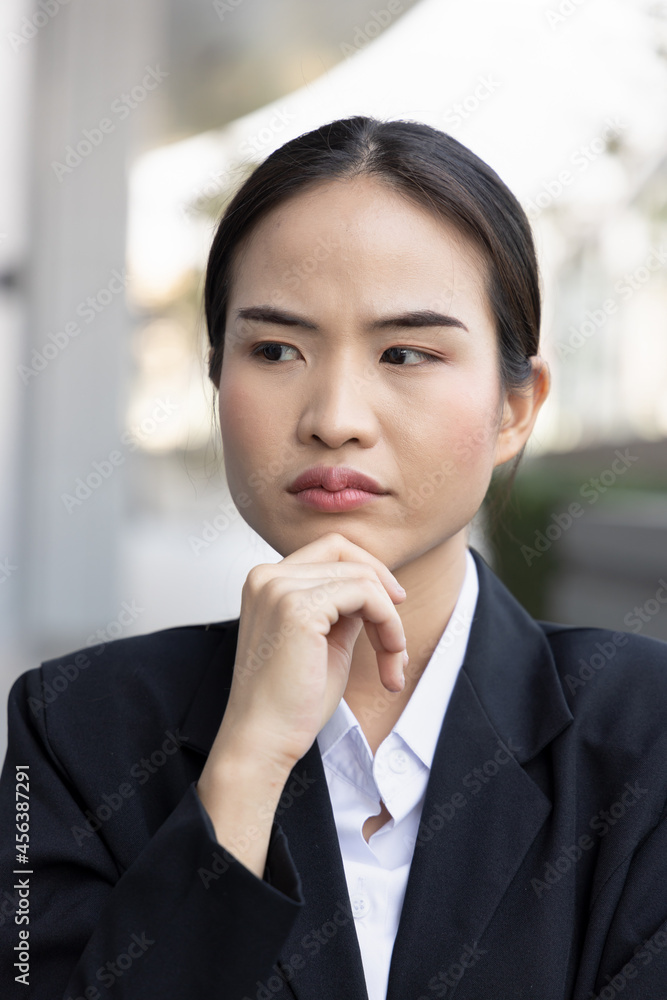 Stressed and unhappy asian woman office worker thinking