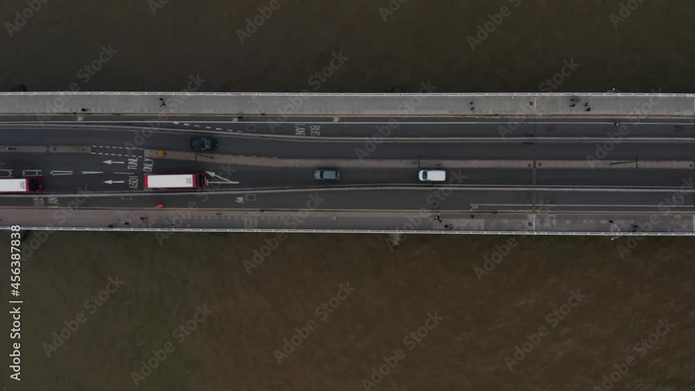 Aerial birds eye overhead top down ascending view of traffic on Waterloo Bridge over Thames river. Cars and buses driving on road. London, UK Aerial birds eye overhead top down ascending view of traffic on Waterloo Bridge over Thames river. Cars and buses driving on road. London, UK
