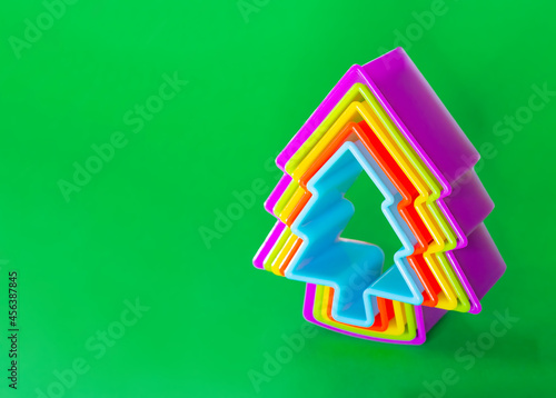 Christmas tree symbol on a green background. Christmas cookie cutters.