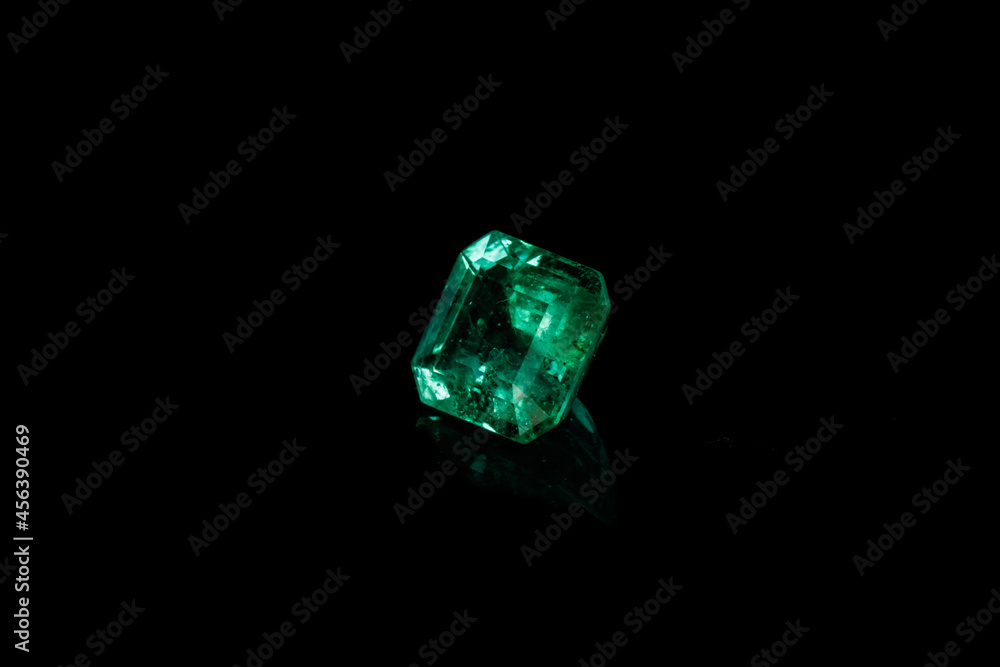 Fototapeta premium Macro mineral Emerald gemstone faceted on black background