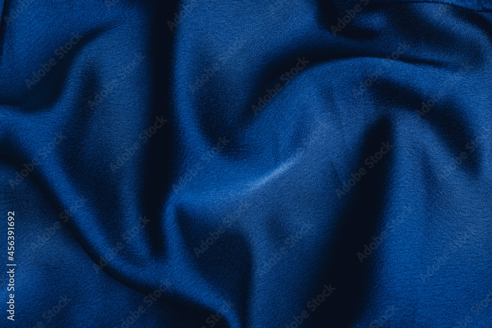 Dark blue fabric laid in soft folds Dark blue fabric laid in soft folds