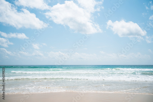 Landscape waves nature splashes beach sunlight.Blue sea waves and sky on sand famous beach.clean sea white clouds soft daylight.