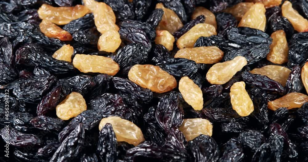 Raisins background rotate slowly. Sweet raisins slow sliding. Close up food background. Gastronomy concept, organic food. Macro fruit dolly shot. Assorted colorful raisins, close up. Raisins background rotate slowly. Sweet raisins slow sliding. Close up food background. Gastronomy concept, organic food. Macro fruit dolly shot. Assorted colorful raisins, close up.