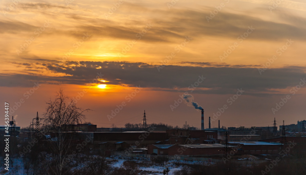 Sunset over the industrial area of the city in winter