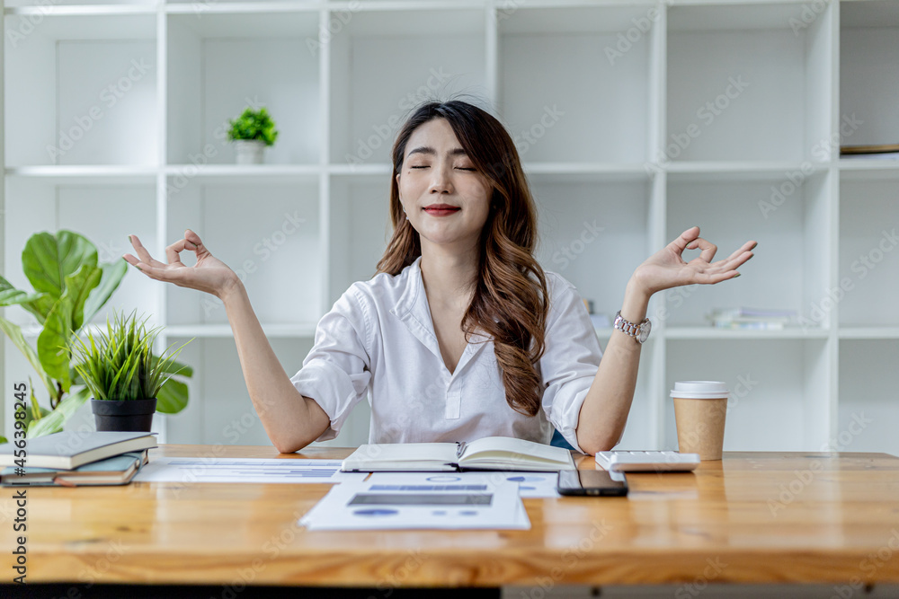 Asian working woman relaxing, a businesswoman in office, she is relaxing after working hard for a long time, causing fatigue and stress to take a break, she has office syndrome . Hard work concept. Asian working woman relaxing, a businesswoman in office, she is relaxing after working hard for a long time, causing fatigue and stress to take a break, she has office syndrome . Hard work concept.