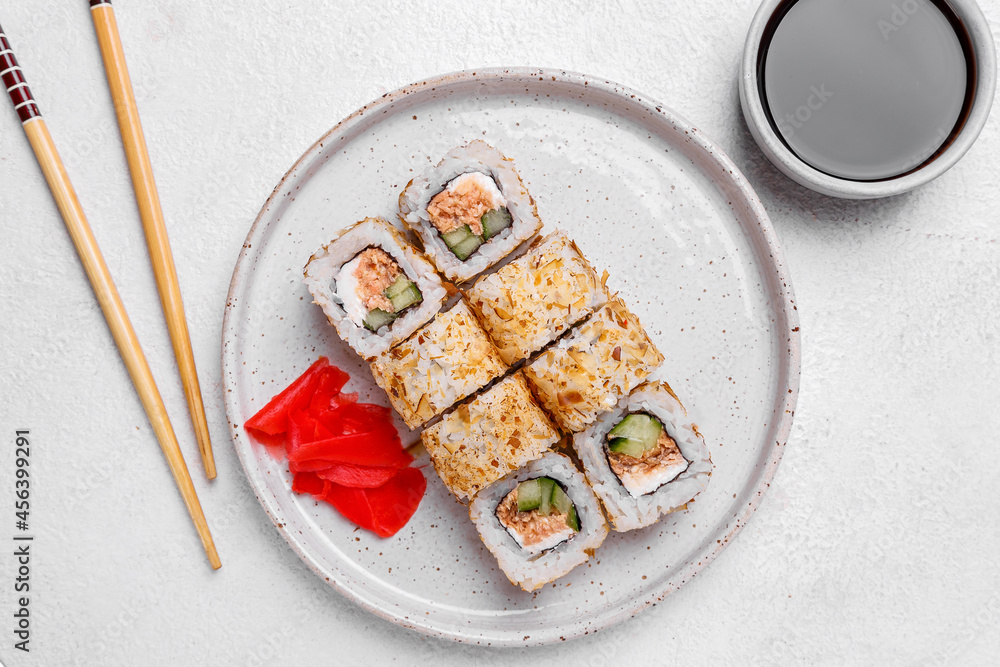sushi rolls with salmon cucumber ginger soy sauce on white background sushi rolls with salmon cucumber ginger soy sauce on white background