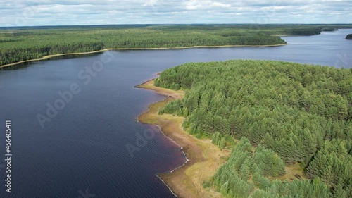 Flight over the taiga forest lake