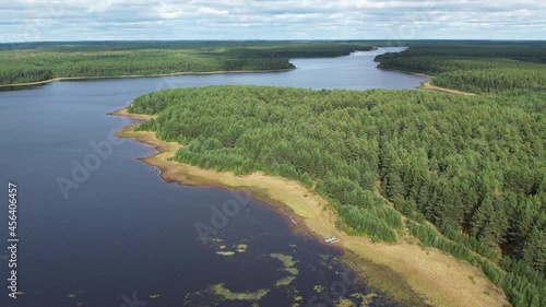 Flight over the taiga forest lake