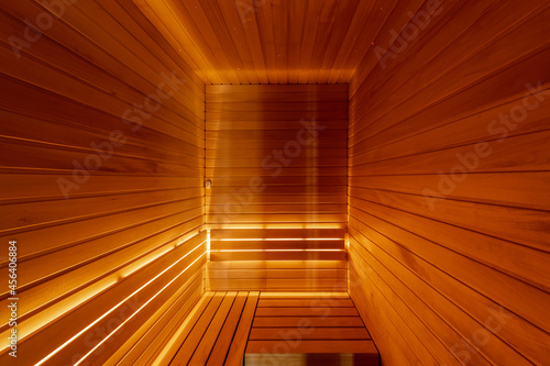 Modern Finnish Sauna interior. Full frame wooden planks background in empty spa room. Healthy lifestyle concept