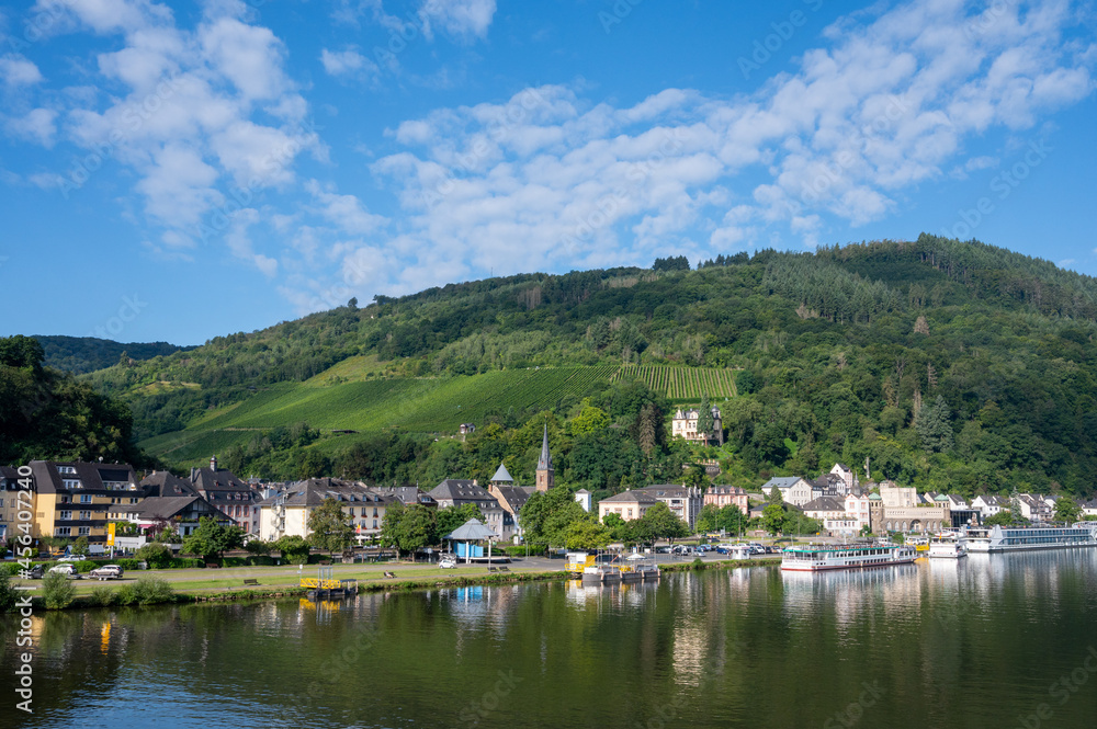 View on Mosel river, hills with vineyards and old town Traben-Trarbach, Germany