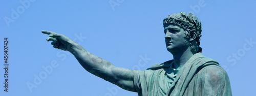 Slika na platnu Anzio - Italy, 29 July 2011: statue of Nero created by the sculptor Claudio Valenti inaugurated in 2010 on the waterfront of Anzio, with trees and blue sky in the background