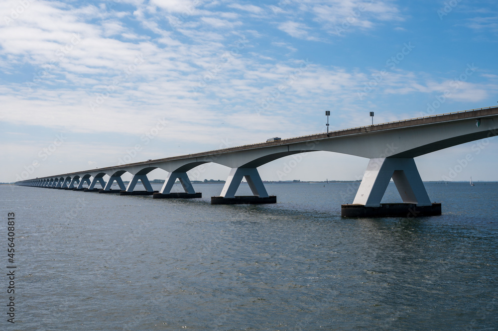 Obraz premium View on longest bridge in the Netherlands, Zealand bridge spans Eastern Scheldt estuary, connects islands of Schouwen-Duiveland and Noord-Beveland in province of Zeeland.
