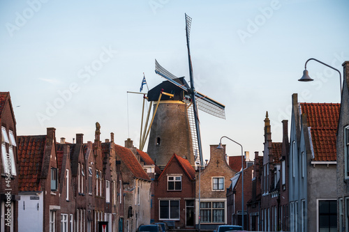 Fototapeta Naklejka Na Ścianę i Meble -  Walking in old Dutch town Zierikzee with old windmill, small houses and streets