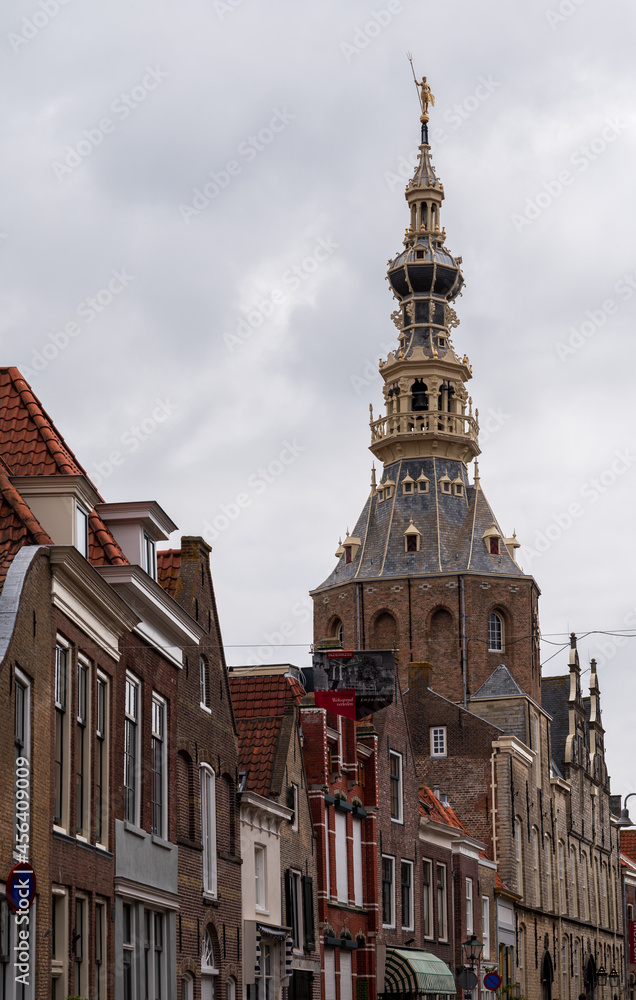 Obraz premium Walking in old Dutch town Zierikzee with old church tower, small houses and streets