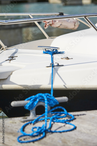 Mooring rope and bollard on sea water and yachts background