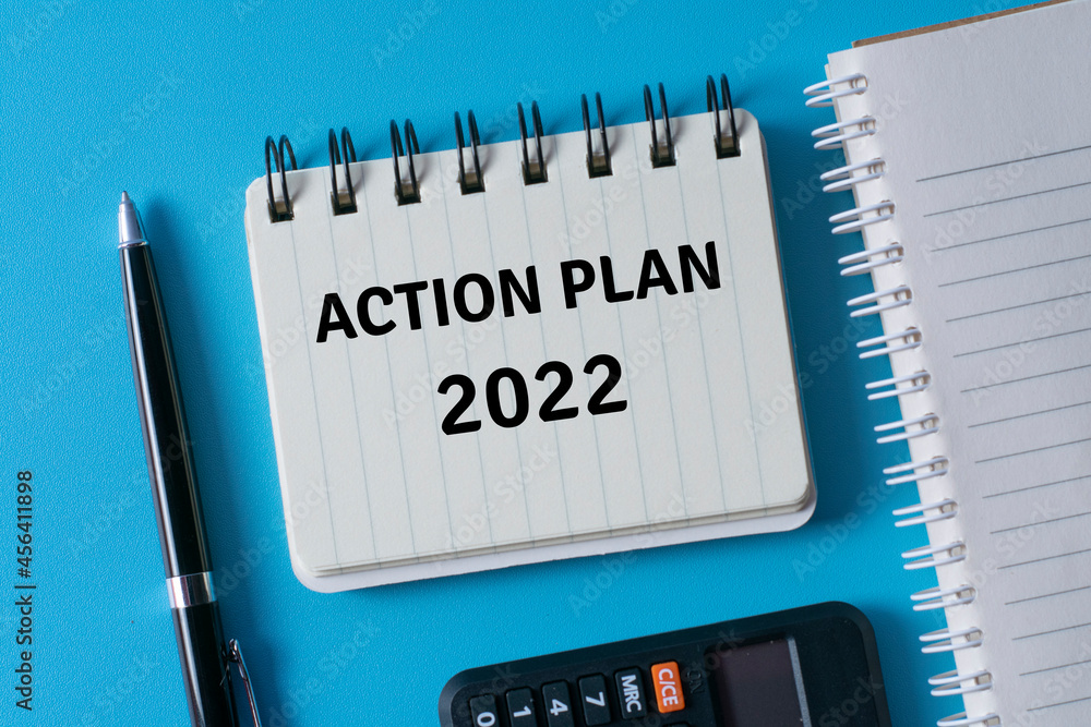 Action plan 2022 written in a notebook - business concept.