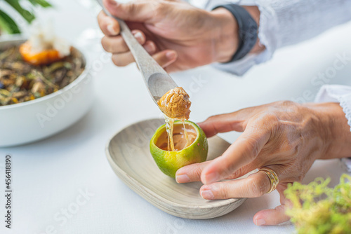 a person tasting a haute cuisine dish based on lemon, foie grass and honey. Gourmet concept and haute cuisine. photo