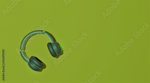 Flat lay design of music concept with headphone on  mild green background with copy space  flat lay.