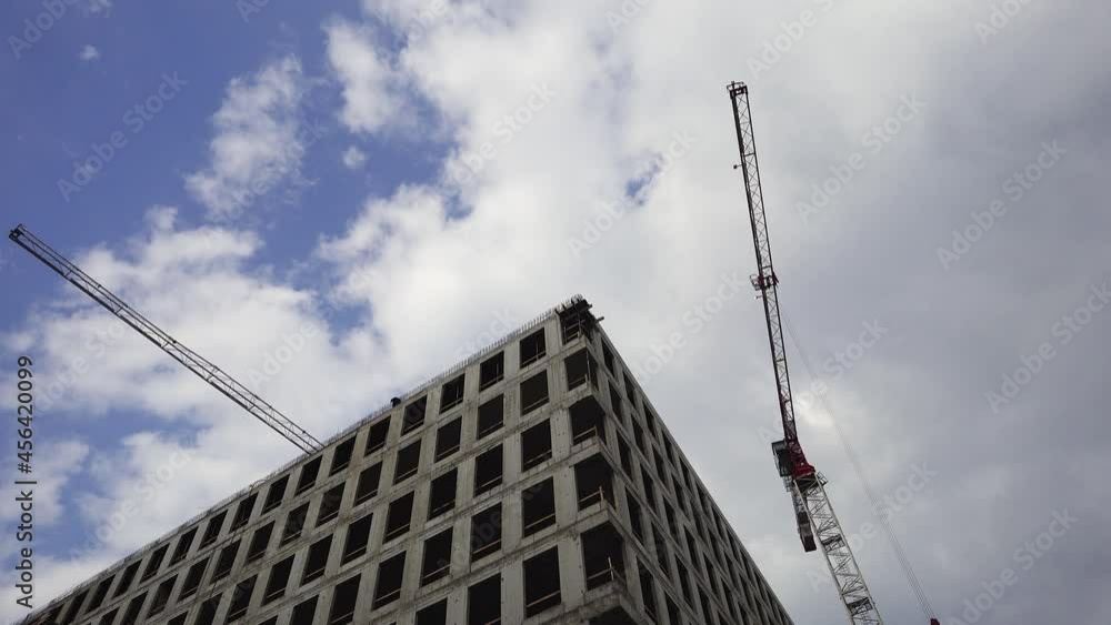 Building framework built with monolithic concrete construction technology, cranes work on the construction site Building framework built with monolithic concrete construction technology, cranes work on the construction site