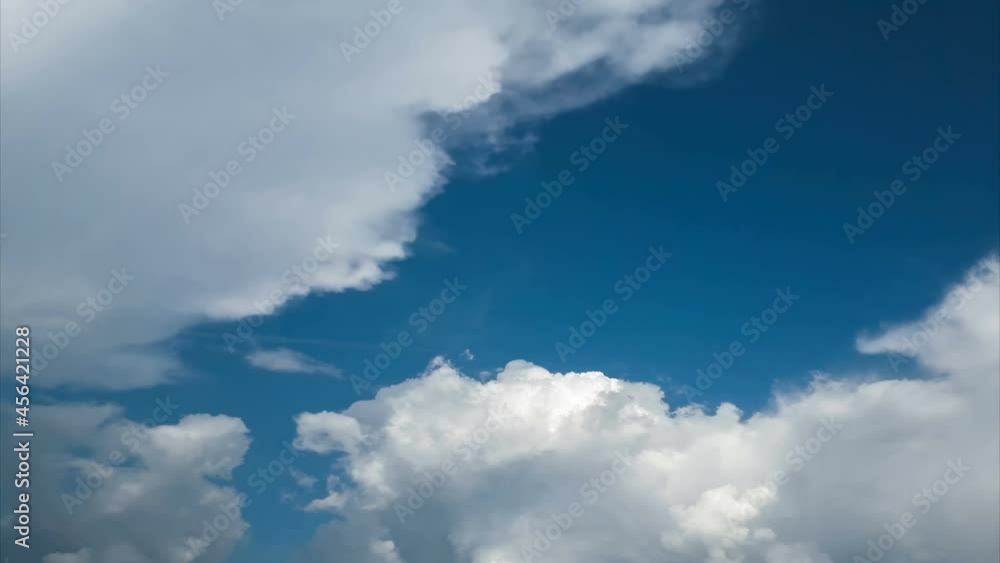 Day cumulus time lapse. Blue sky with moving white clouds Day cumulus time lapse. Blue sky with moving white clouds