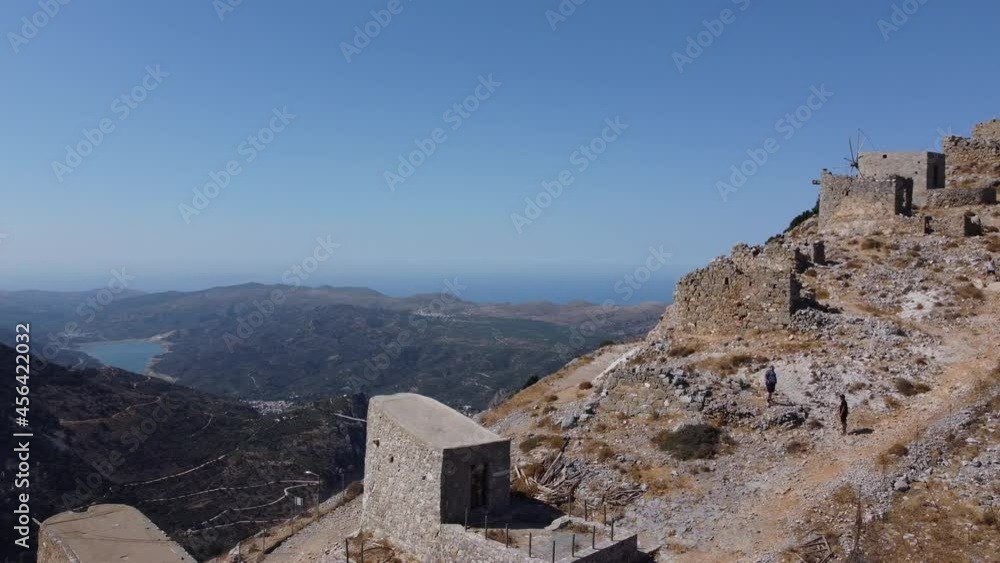 mills in motion on mountain peak by Mediterranean sea, Crete, Greece mills in motion on mountain peak by Mediterranean sea, Crete, Greece