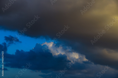 Large white and dark clouds against the blue sky background.