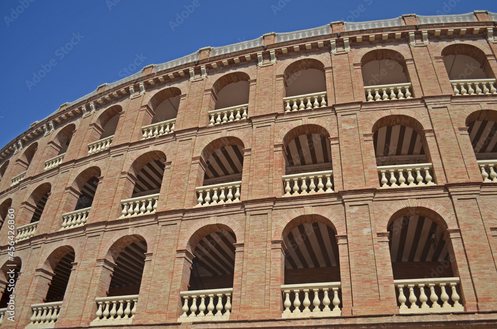 
brick arena with arches and decorative parapets