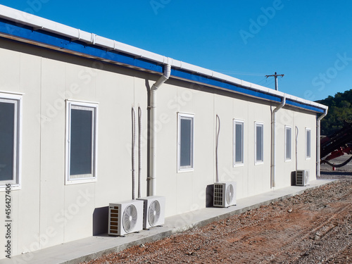 Mobile industrial building. Newly built single storey prefabricated industrial building. Prefabricated office container building at construction site photo
