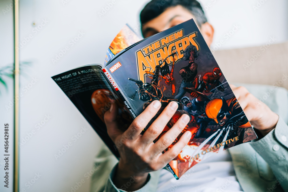 Naklejka premium Man reads comic book in living room at home. Rostov-on-Don, Russia. 8 September 2021