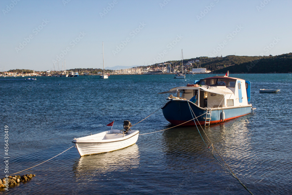 Fototapeta premium Empty fishing boats with Turkish Flags moored on the blue sea,blurred background