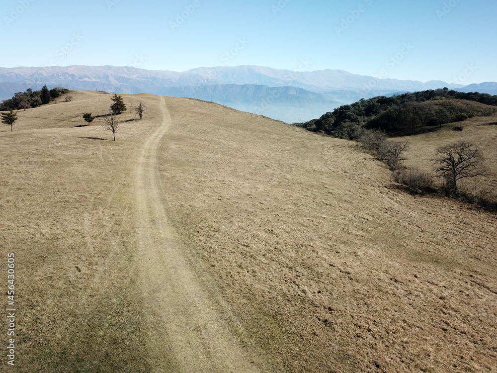 Villa Nougues area in the hills of Tucumán, town, meadow, wooded hills in autumn Villa Nougues area in the hills of Tucumán, town, meadow, wooded hills in autumn