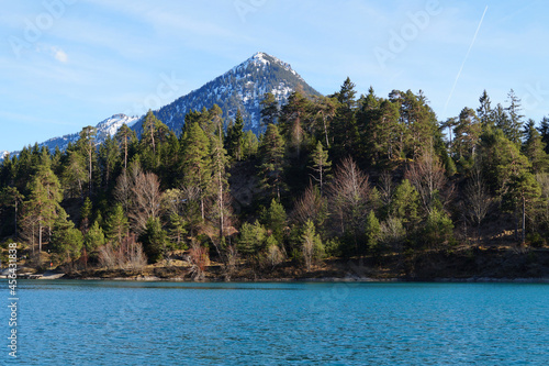 Fototapeta Naklejka Na Ścianę i Meble -  a beautiful little blue alpine lake and the snowy peaks of the Alps in Fuessen in Allgaue, Bavaria (Germany)	