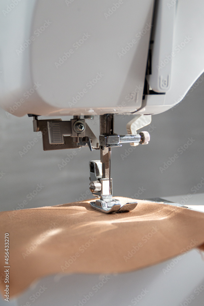 sewing machine close up view with natural sunlight, slow fashion and home sewing concept
