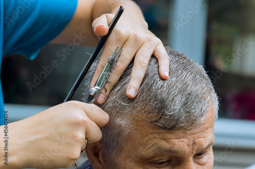 A hairdresser stylish haircut for a man in a home