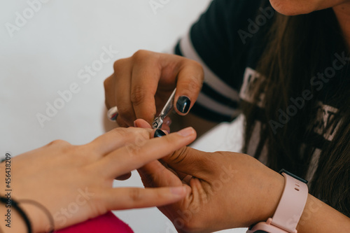 Woman hands doing manicure in salon.