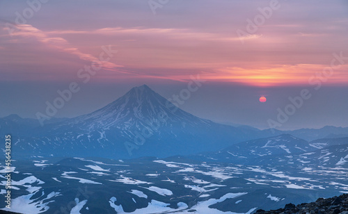 Sunrise from the top of the Gorely volcano and view to the Vilyuchinsky volcano in the Kamchatka Peninsula , Russia.