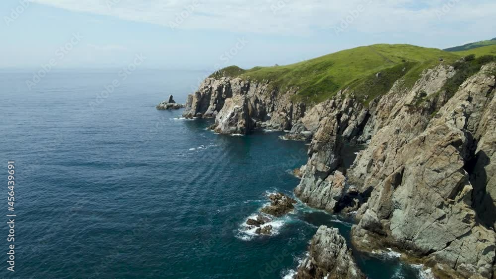 Aerial view, Rocks, Pacific Ocean, green grass on the mountains , bay Aerial view, Rocks, Pacific Ocean, green grass on the mountains , bay