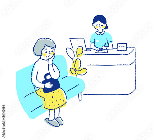 病院の待合室　看護師と困った表情の女性患者