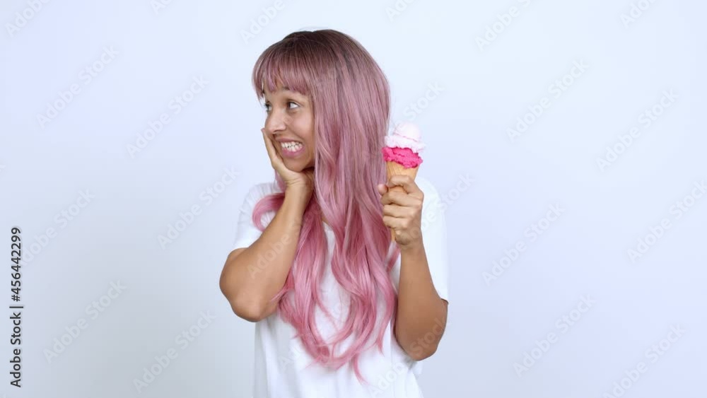 holding a cornet ice cream with surprise and shocked facial expression over isolated background holding a cornet ice cream with surprise and shocked facial expression over isolated background