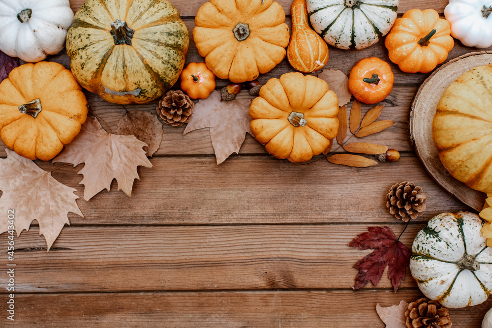 Thanksgiving flat lay. Pumpkins, autumn leaves on rustic wood with space for text. Happy Thanksgiving and Halloween template. Hello Autumn. Harvest Thanksgiving flat lay. Pumpkins, autumn leaves on rustic wood with space for text. Happy Thanksgiving and Halloween template. Hello Autumn. Harvest