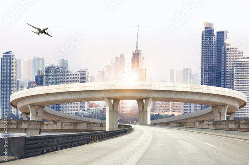 Suspension bridge connect to highway concrete road curve,Highway overpass motion with modern city background