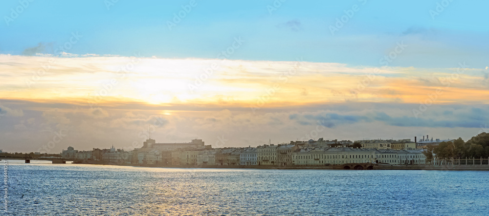 Embankment of the Neva river in Saint Petersburg at sunrise. Panoramic cityscape. Deserted streets of the city center, city is sleeping