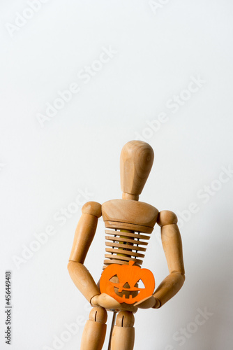 solitary manikin or mannikin poses with a flat jack o lantern photo