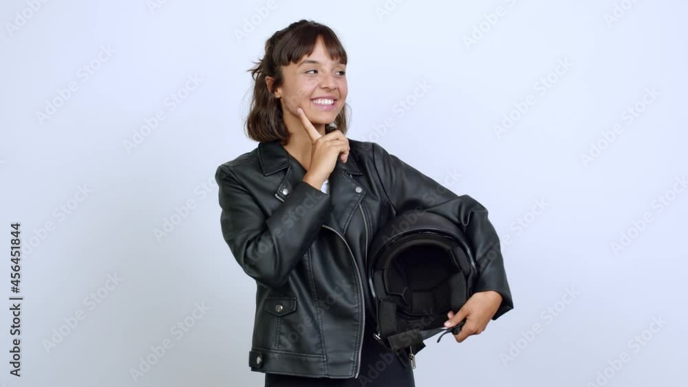 holding a motorcycle helmet standing and thinking an idea pointing the finger up over isolated background holding a motorcycle helmet standing and thinking an idea pointing the finger up over isolated background