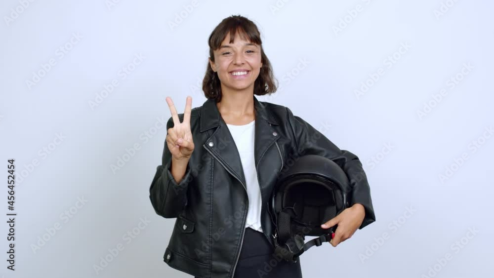 holding a motorcycle helmet showing ok sign with fingers over isolated background holding a motorcycle helmet showing ok sign with fingers over isolated background